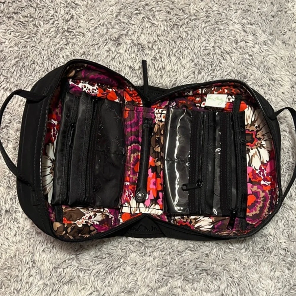 Vera Bradley black toiletry bag with 4 zippered pockets inside. Great condition!